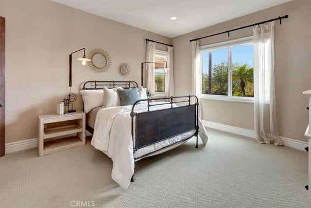 a kitchen with stainless steel appliances kitchen island granite countertop a table chairs and a refrigerator