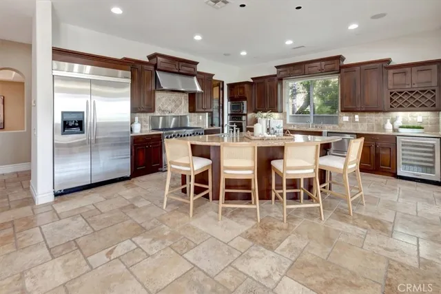 a view of a livingroom with entryway and a chandelier fan