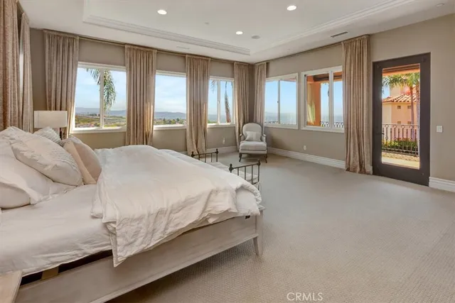 a bedroom with a bed and a dresser with mirror