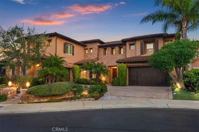 an aerial view of a house with a yard and lake view