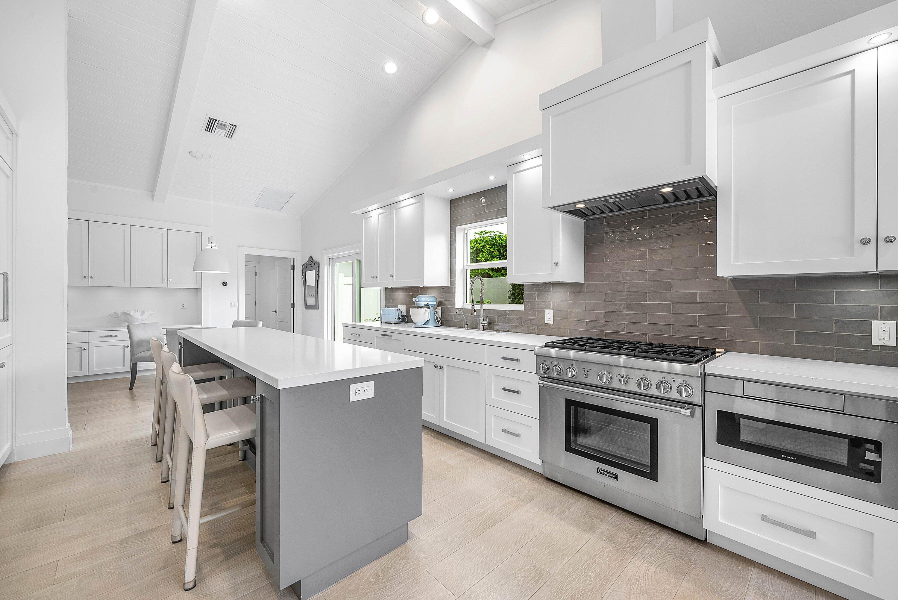 4199 Bocaire Boulevard Boca Raton, FL 33487 - Photo 18 of 82 a kitchen with a stove a sink and a refrigerator