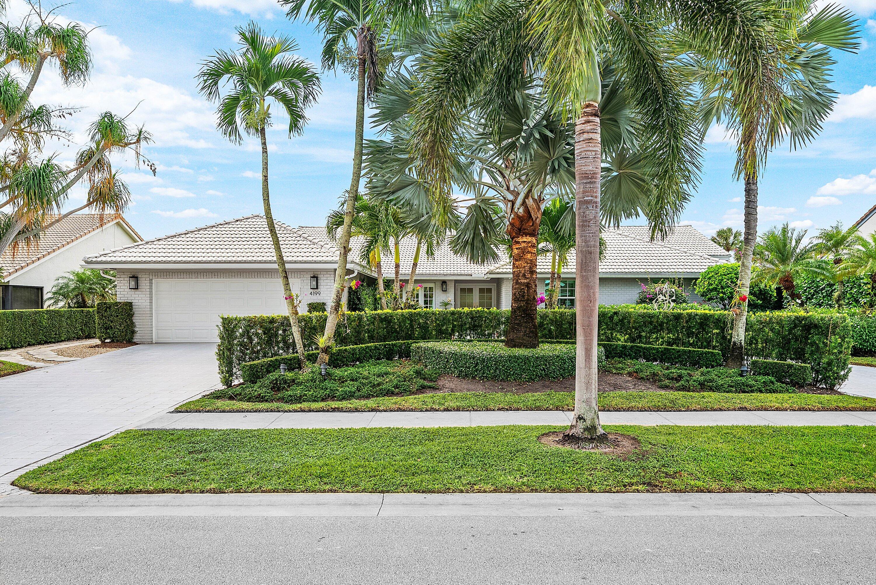 4199 Bocaire Boulevard Boca Raton, FL 33487 - Photo 2 of 82 a view of a house with a yard and palm trees