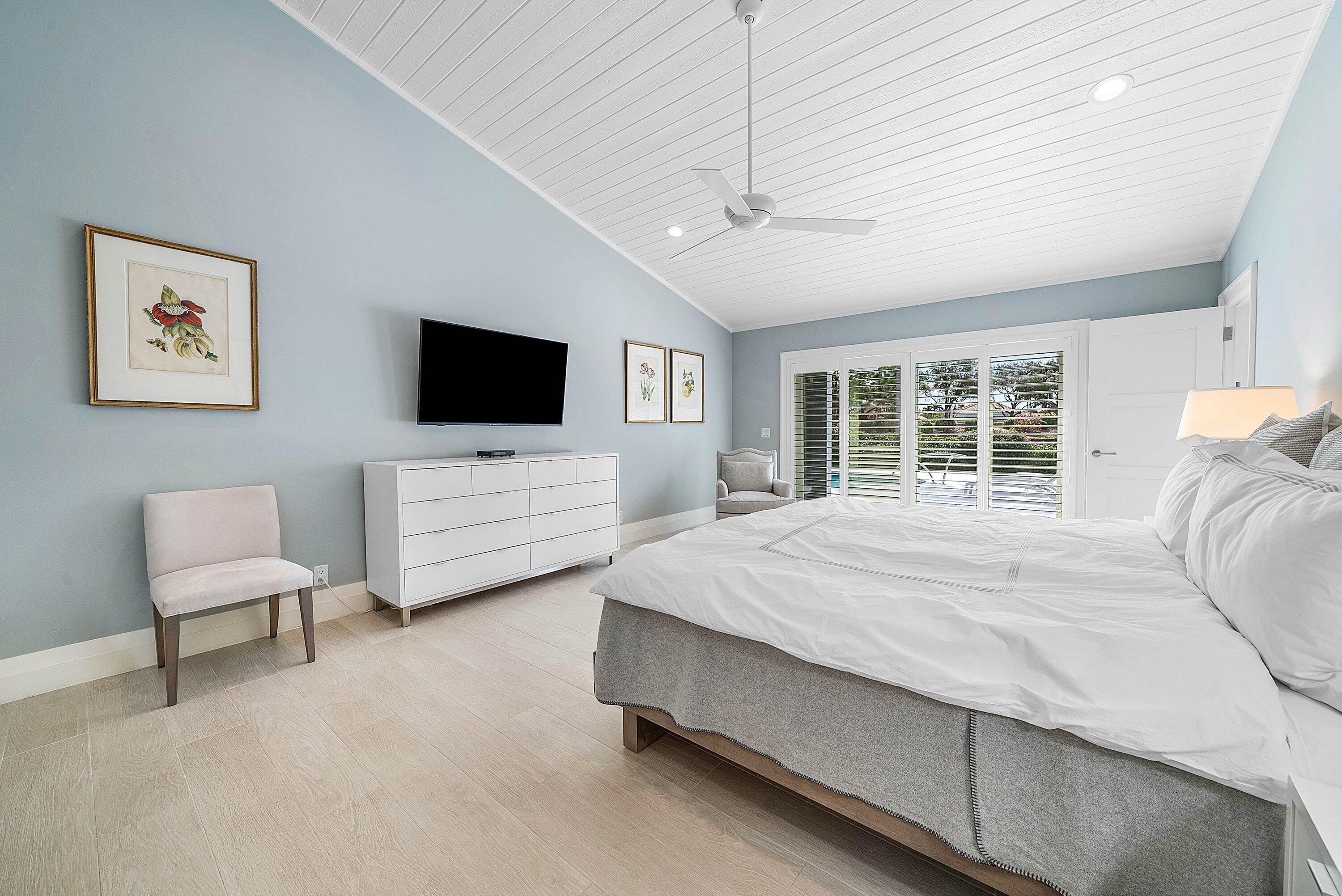 4199 Bocaire Boulevard Boca Raton, FL 33487 - Photo 27 of 82 a spacious bedroom with a bed and a flat screen tv
