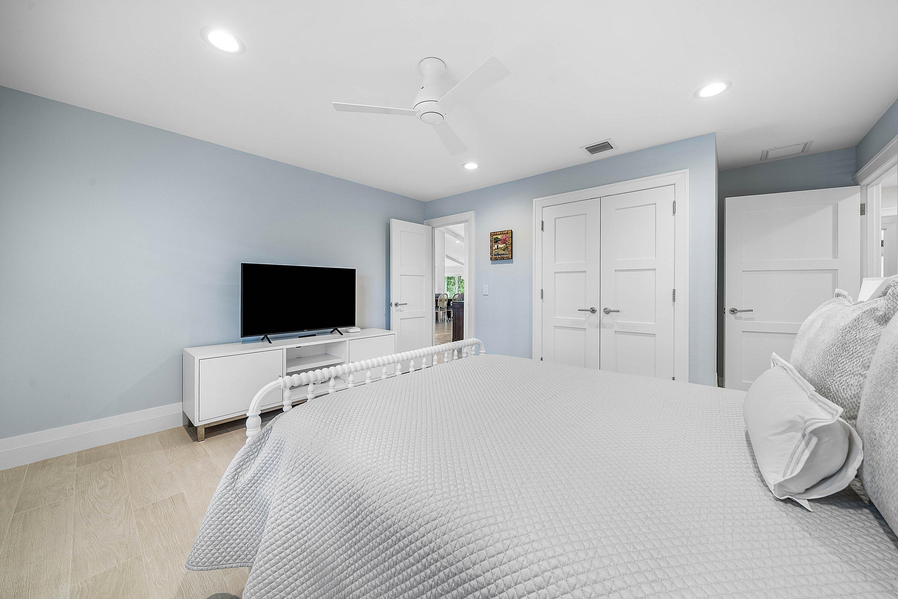 4199 Bocaire Boulevard Boca Raton, FL 33487 - Photo 36 of 82 a bedroom with a bed and a flat screen tv