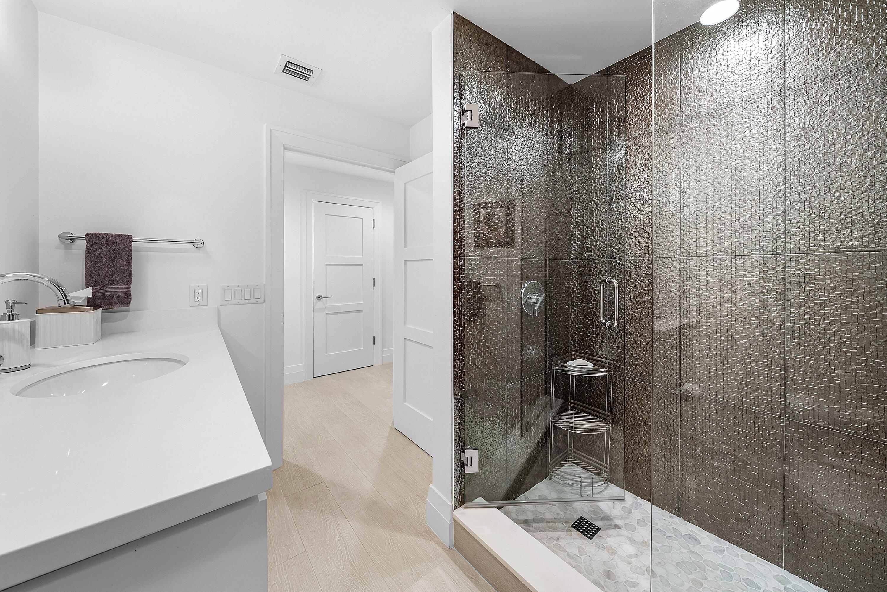 4199 Bocaire Boulevard Boca Raton, FL 33487 - Photo 38 of 82 a bathroom with a sink a toilet and shower