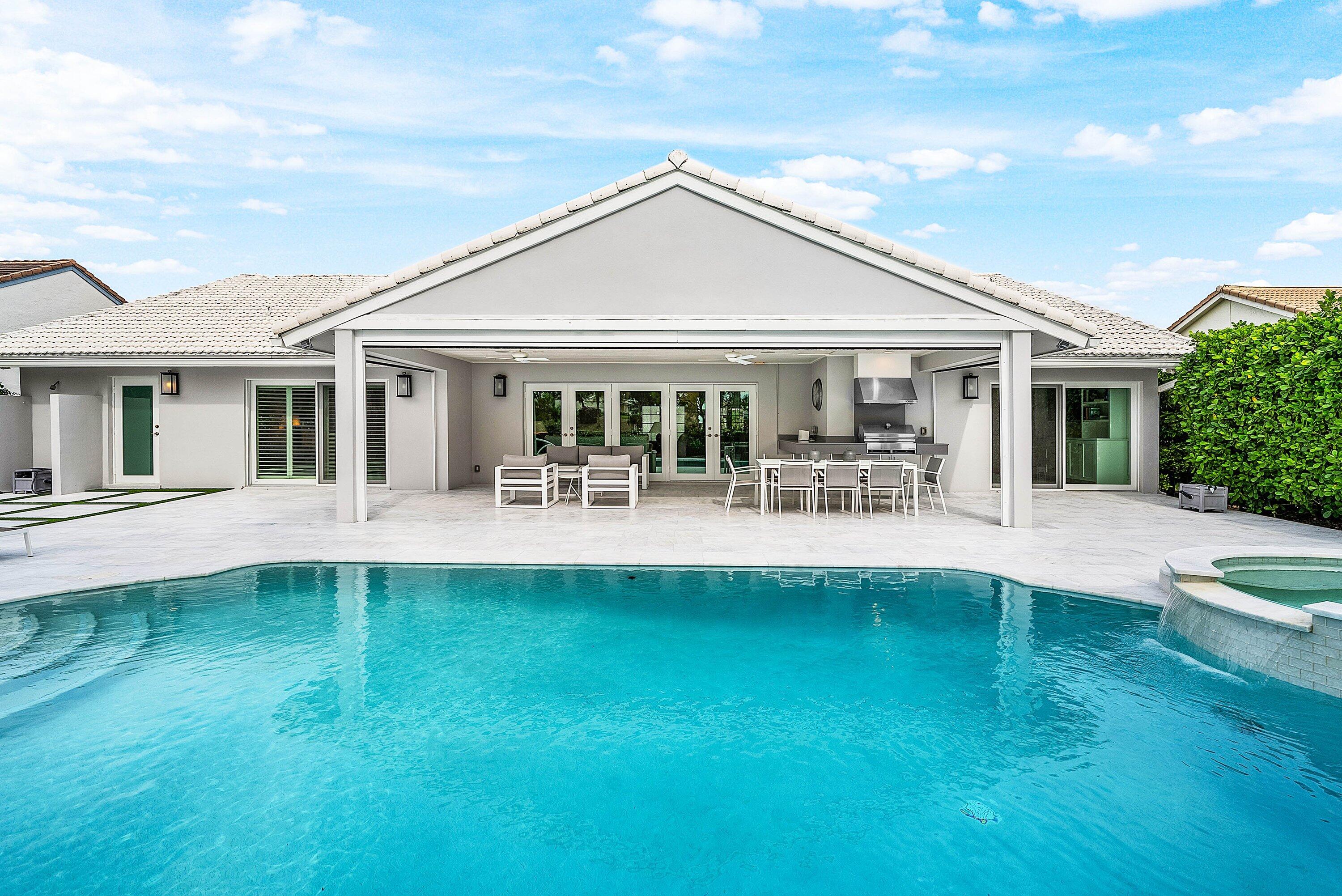 4199 Bocaire Boulevard Boca Raton, FL 33487 - Photo 41 of 82 a front view of a house with a yard table and chairs