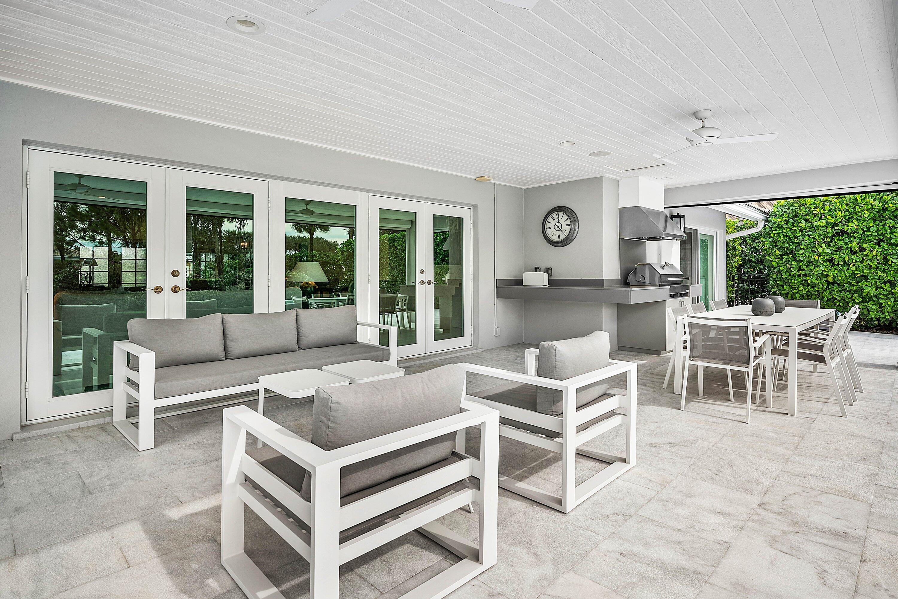 4199 Bocaire Boulevard Boca Raton, FL 33487 - Photo 43 of 82 a living room with a large window and a clock