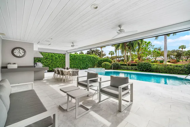 a view of a dining room with furniture large windows and wooden floor