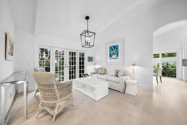 a large kitchen with stainless steel appliances lots of white cabinets
