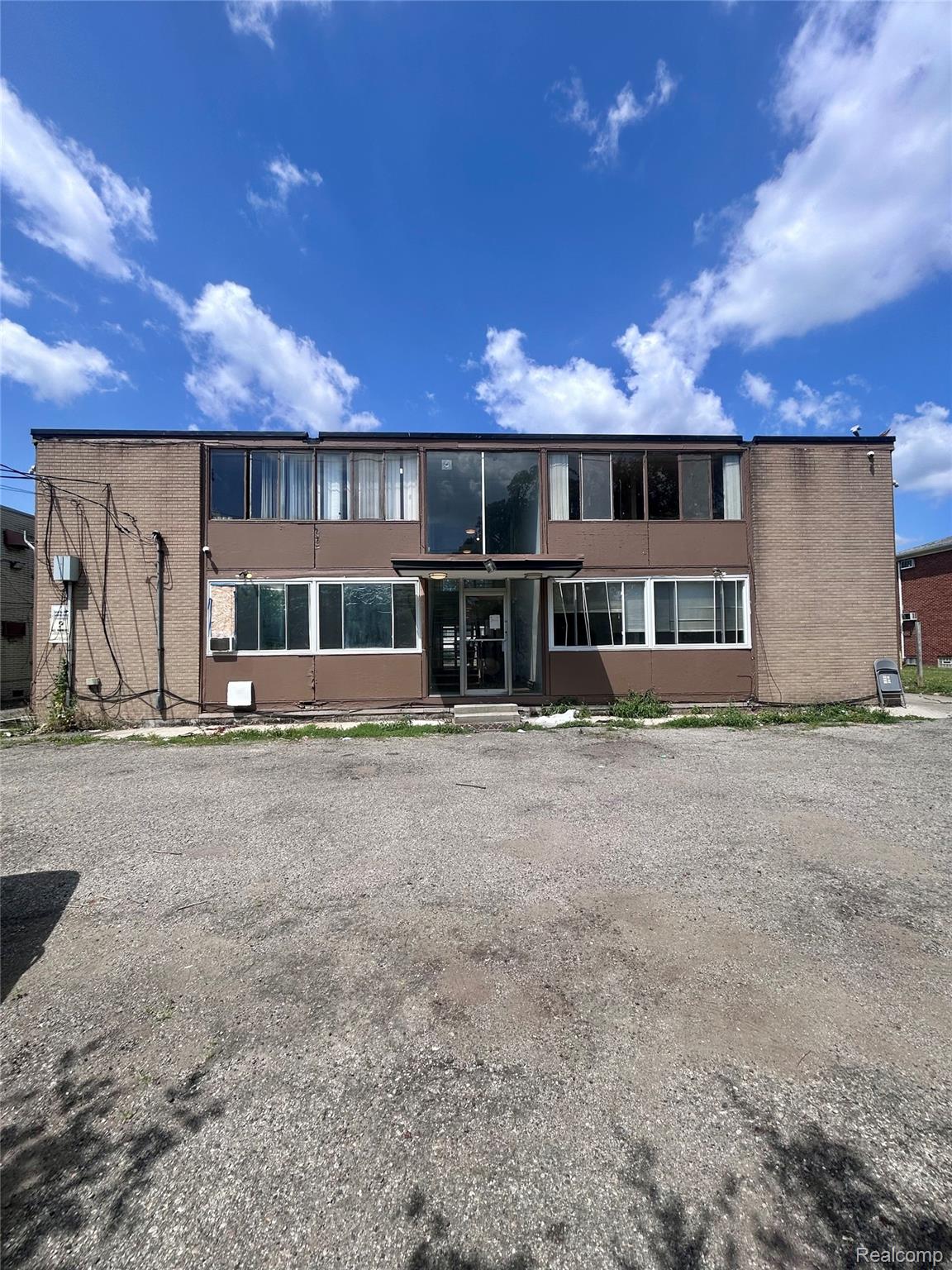 15080 Greenfield Road Detroit, MI 48227 - Photo 4 of 6 Two-story commercial building featuring a brick facade and extensive fenestration