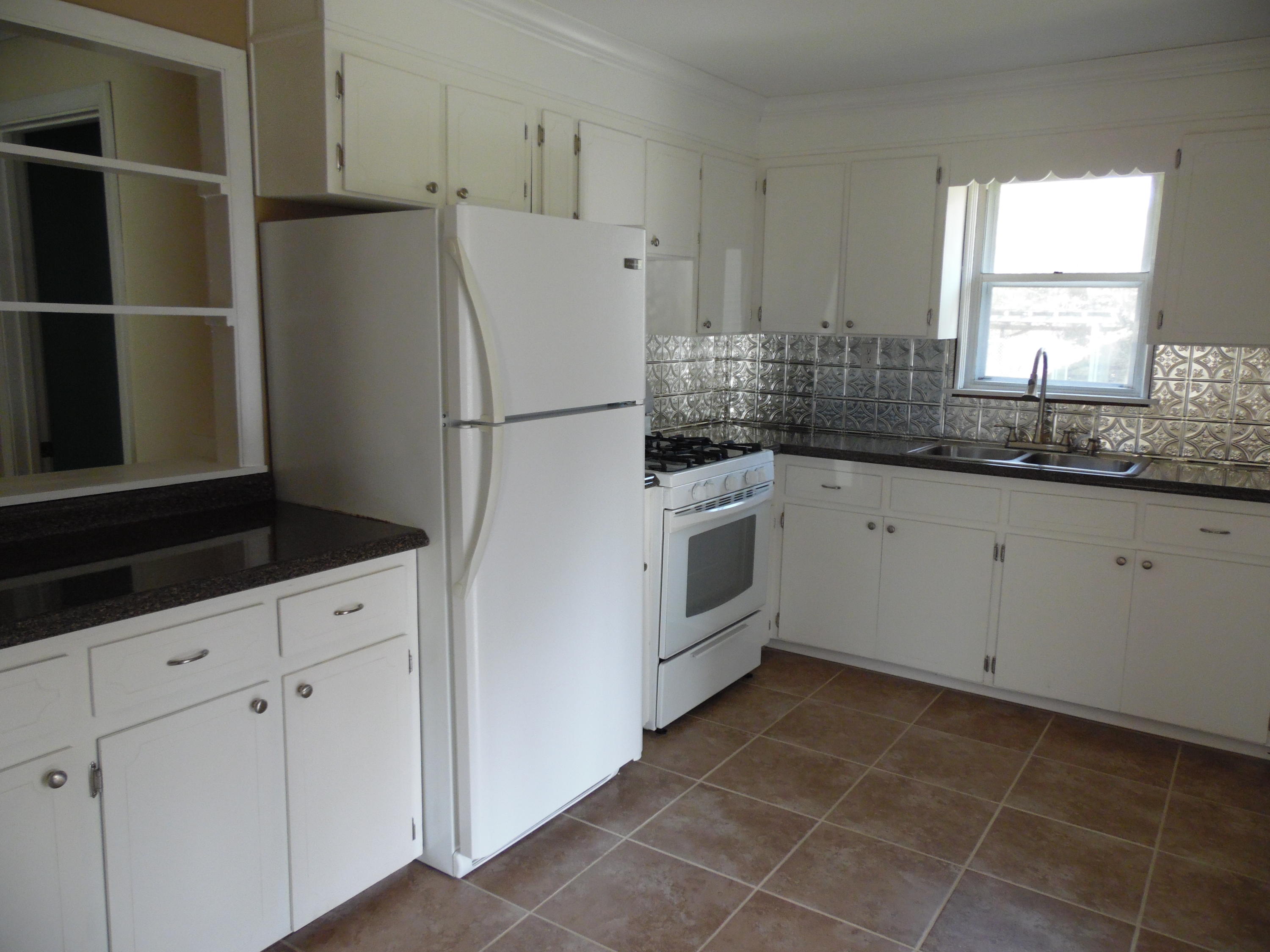 4005 King Lake Road DeFuniak Springs, FL 32433 - Photo 14 of 35 a kitchen with granite countertop white cabinets and white appliances