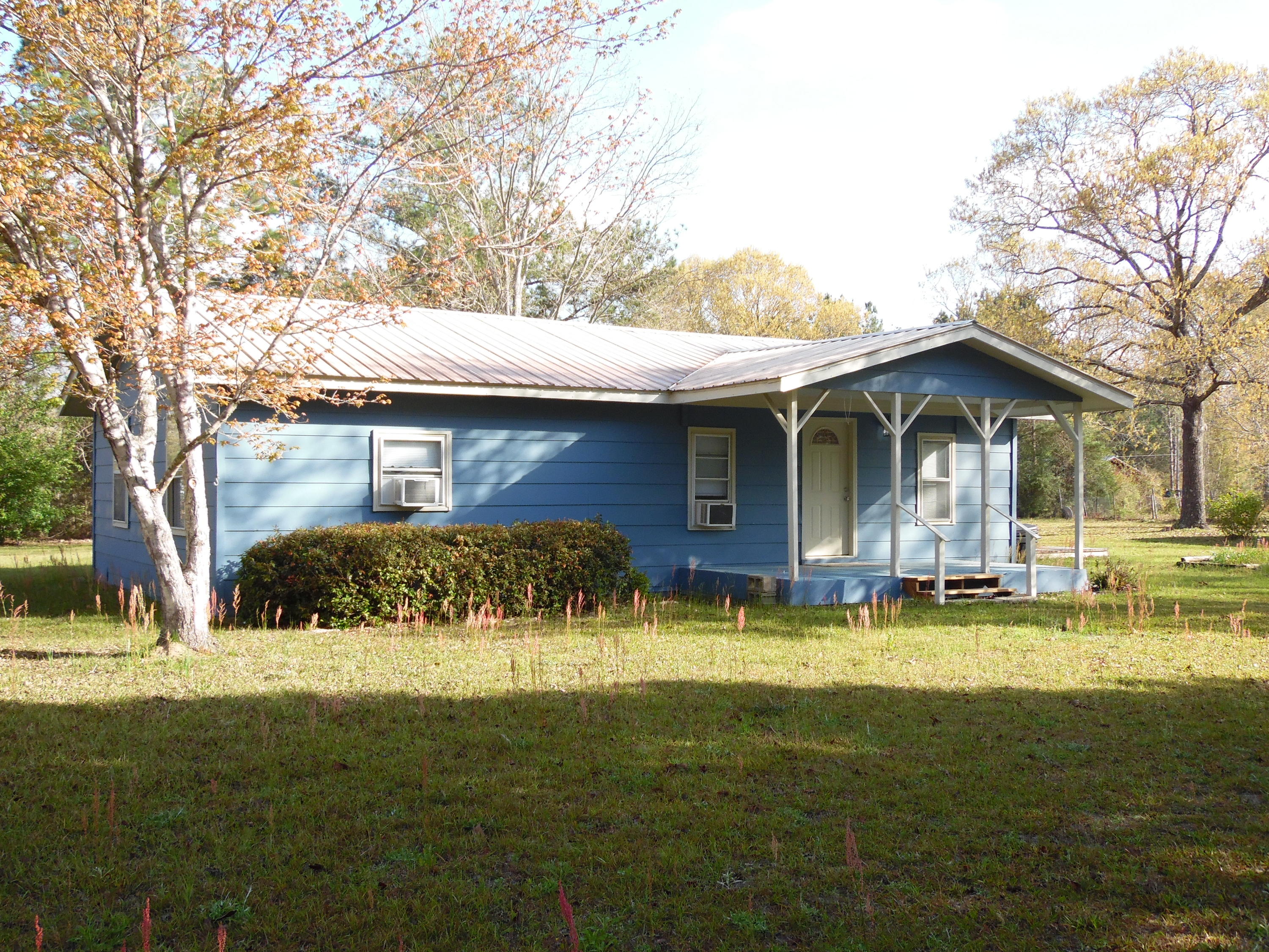 4005 King Lake Road DeFuniak Springs, FL 32433 - Photo 3 of 35 a view of a house with a yard patio and fire pit