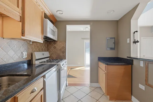a kitchen with a refrigerator sink and cabinets