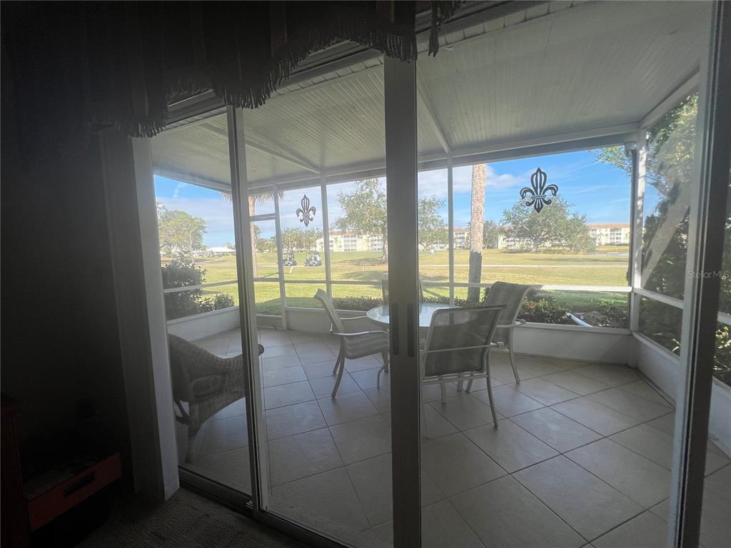338 Cerromar Way, Unit 4 Venice, FL 34293 - Photo 14 of 41 a dining room with furniture and a floor to ceiling window