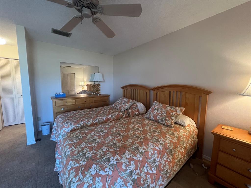 338 Cerromar Way, Unit 4 Venice, FL 34293 - Photo 16 of 41 a bedroom with a bed and a chandelier