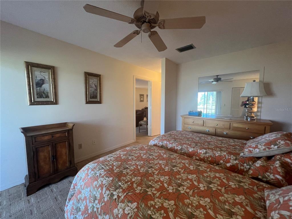 338 Cerromar Way, Unit 4 Venice, FL 34293 - Photo 17 of 41 a bedroom with a bed and a chandelier