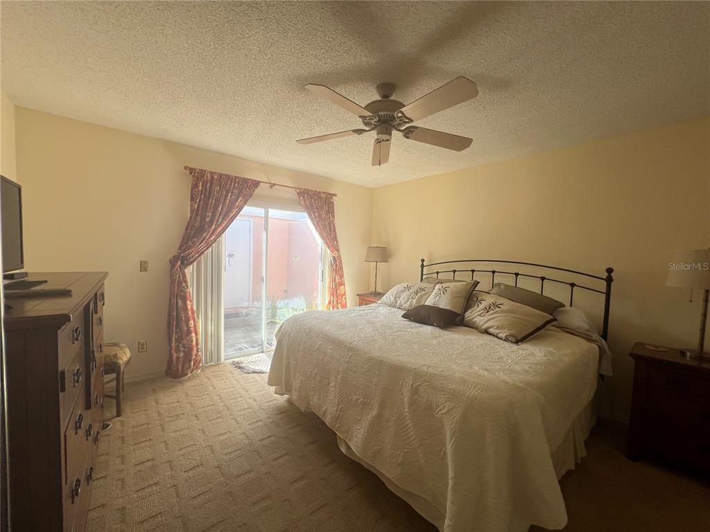 338 Cerromar Way, Unit 4 Venice, FL 34293 - Photo 24 of 41 a bedroom with a bed and a mirror