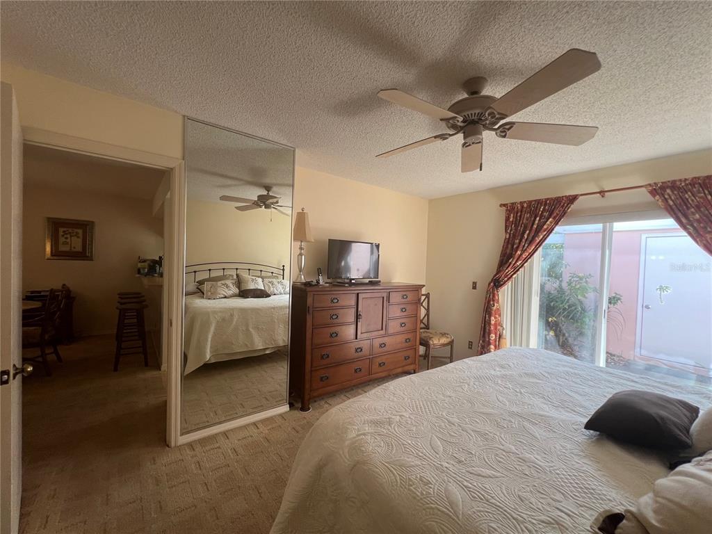 338 Cerromar Way, Unit 4 Venice, FL 34293 - Photo 25 of 41 a bedroom with a bed and a chandelier