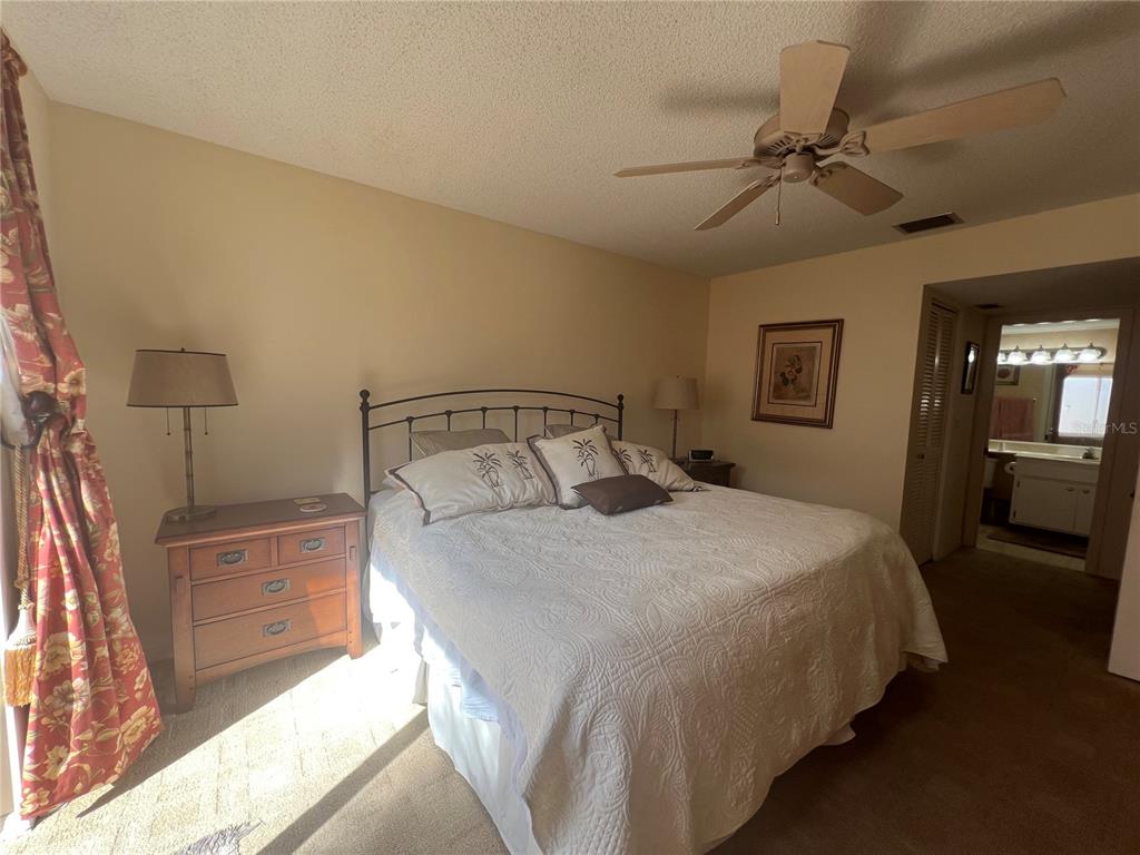 338 Cerromar Way, Unit 4 Venice, FL 34293 - Photo 27 of 41 a bedroom with a bed and a chandelier