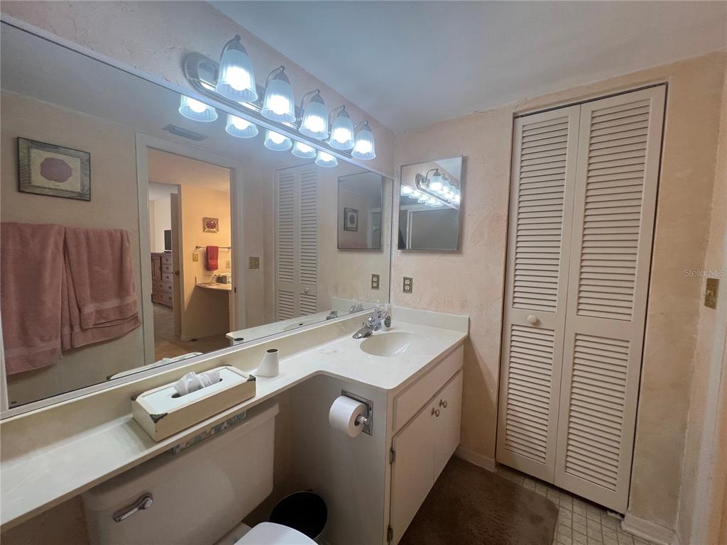 338 Cerromar Way, Unit 4 Venice, FL 34293 - Photo 31 of 41 a bathroom with a sink a large mirror and a shower