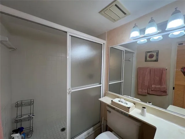 a bedroom with a bed and a view of kitchen