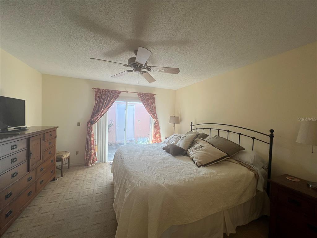 338 Cerromar Way, Unit 4 Venice, FL 34293 - Photo 33 of 41 a bedroom with a bed and a chandelier