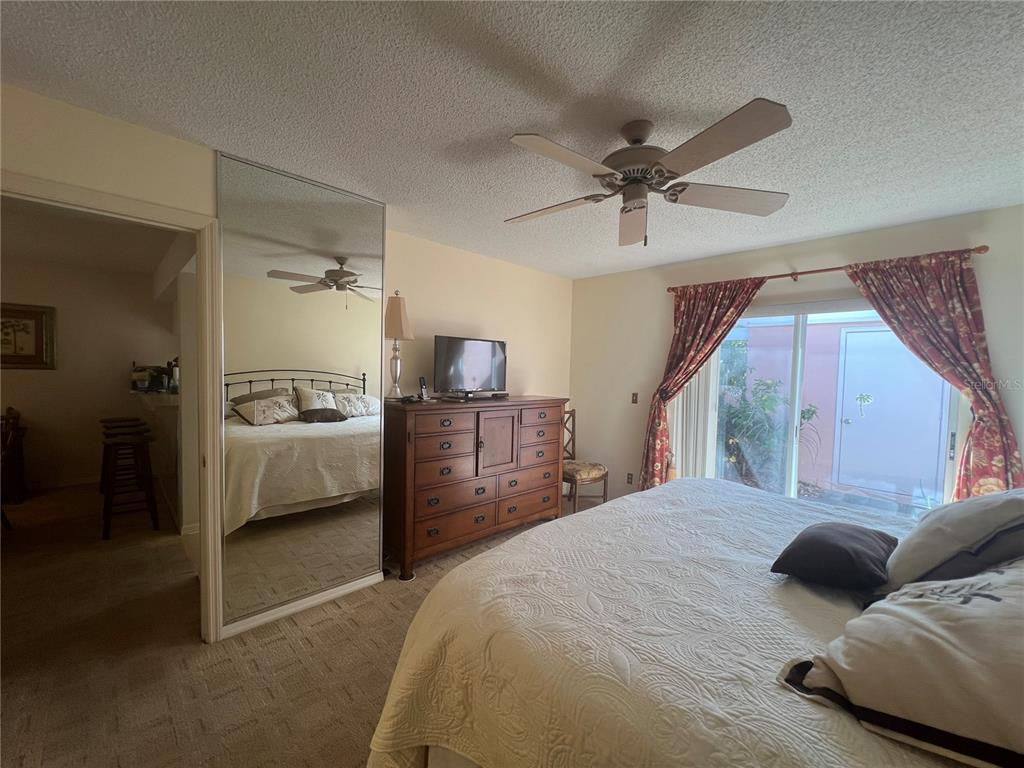 338 Cerromar Way, Unit 4 Venice, FL 34293 - Photo 34 of 41 a bedroom with a bed and a view of kitchen