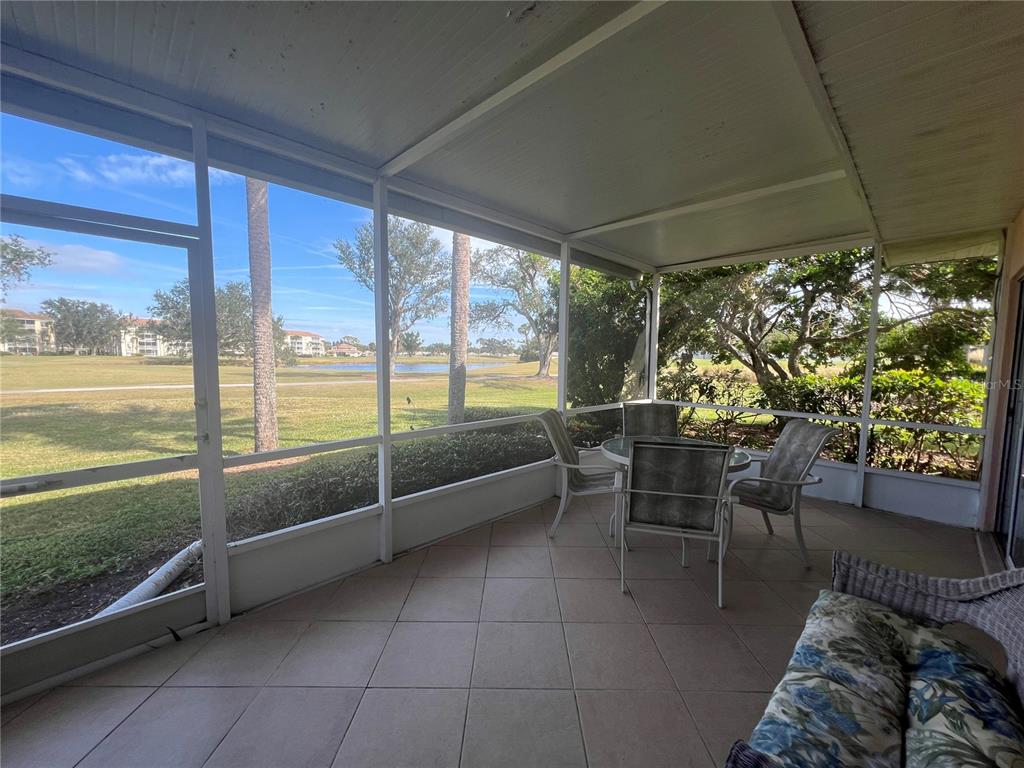 338 Cerromar Way, Unit 4 Venice, FL 34293 - Photo 36 of 41 a view of a porch with furniture and a yard