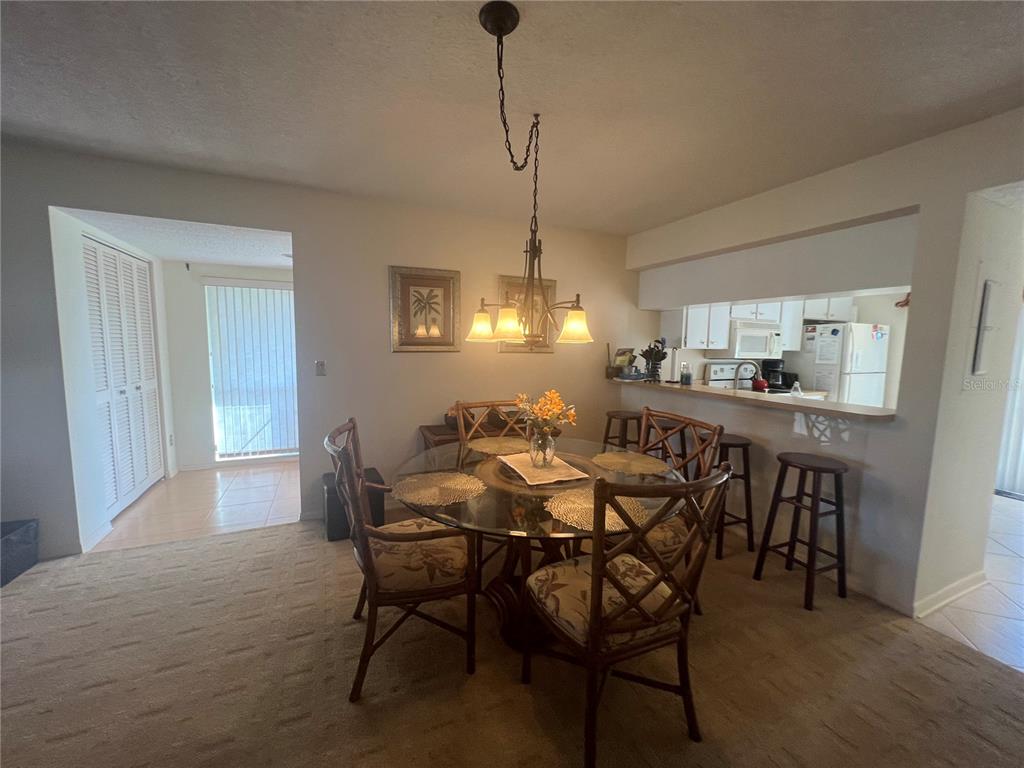 338 Cerromar Way, Unit 4 Venice, FL 34293 - Photo 8 of 41 a dining room with furniture and window