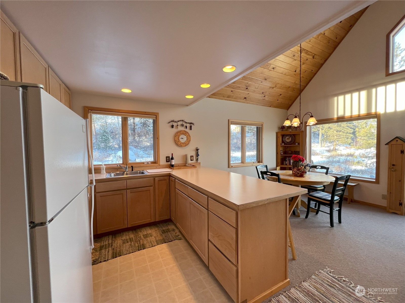 30 Left Fork Wolf Creek Road Winthrop, WA 98862 - Photo 16 of 40 a kitchen with sink refrigerator and dining table