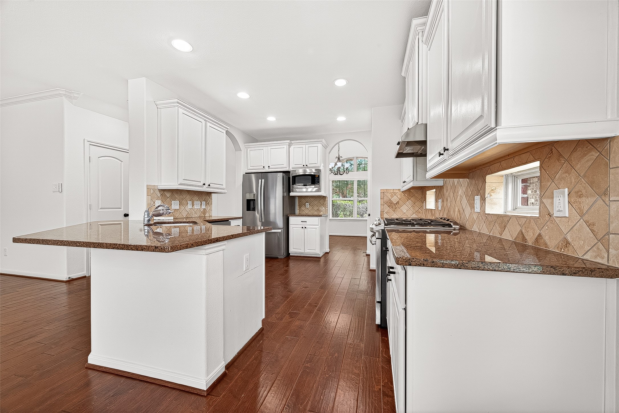 138 South Sawbridge Circle Spring, TX 77389 - Photo 15 of 37 a kitchen with stainless steel appliances granite countertop a refrigerator a stove top oven a sink and dishwasher with wooden floor