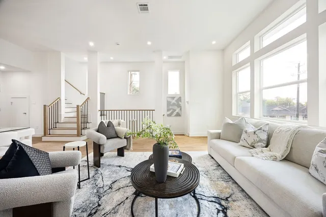 a living room with furniture and a large window