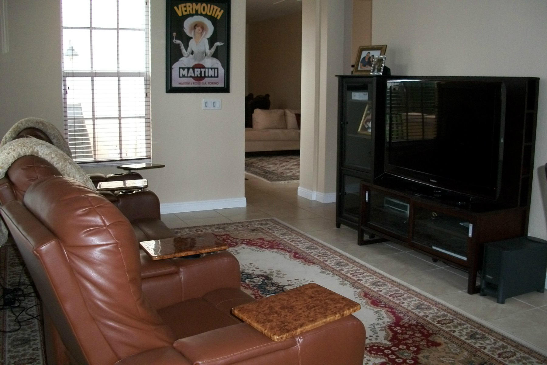 822 Northwest 82nd Place Boca Raton, FL 33487 - Photo 4 of 22 a living room with furniture a flat screen tv and a window