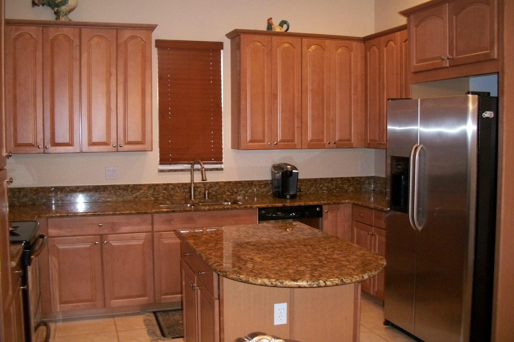 822 Northwest 82nd Place Boca Raton, FL 33487 - Photo 8 of 22 a kitchen with stainless steel appliances granite countertop a sink stove and refrigerator