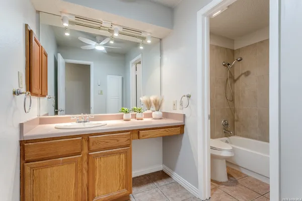 a bathroom with a sink and mirror with toilet