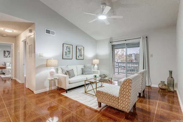 a living room with furniture a table and a large window