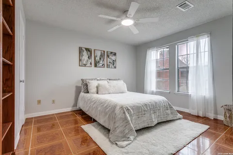 a bedroom with a large bed and a window