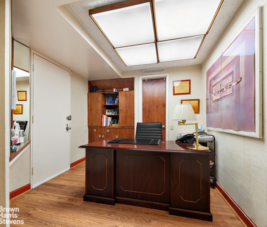 785 Park Avenue, Unit 1D Manhattan, NY 10003 - Photo 3 of 10 a room with wooden floor and furniture
