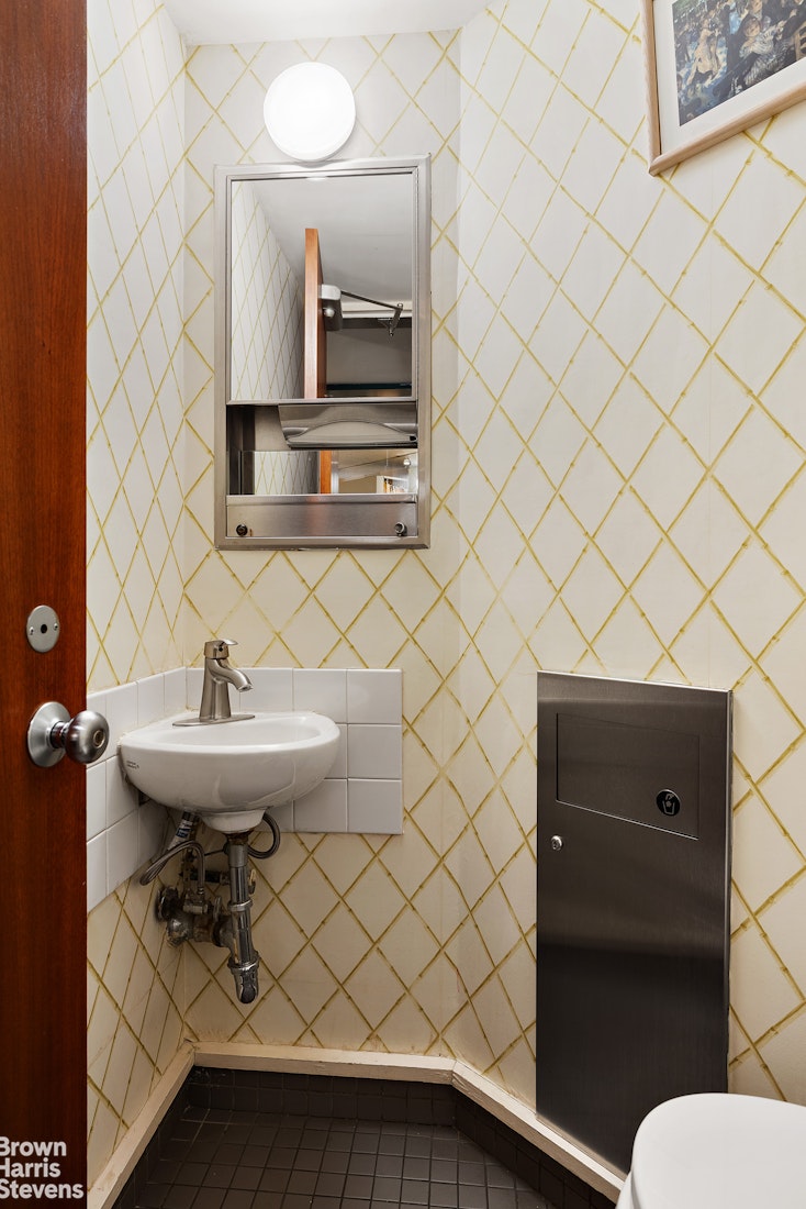 785 Park Avenue, Unit 1D Manhattan, NY 10003 - Photo 6 of 10 a bathroom with a sink a toilet and a mirror