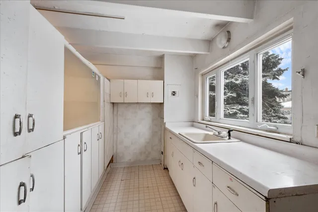 a spacious bathroom with a sink and a large mirror