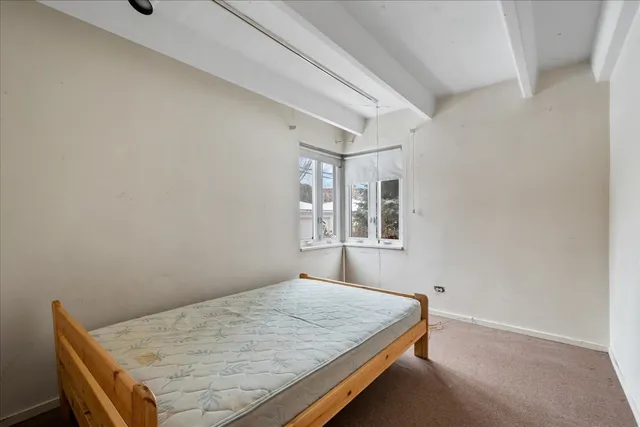 a bedroom with a bed and window