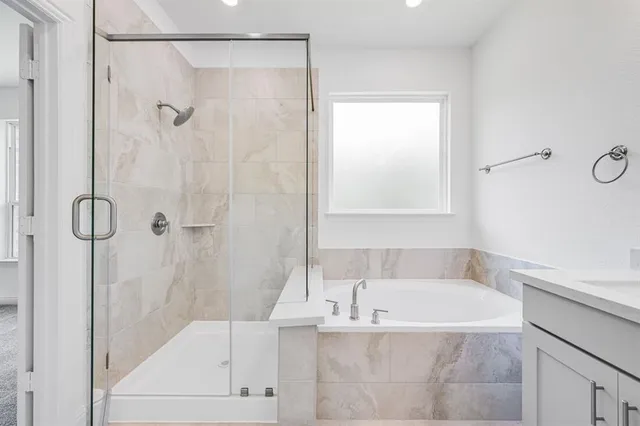 a white bath tub sitting next to a shower