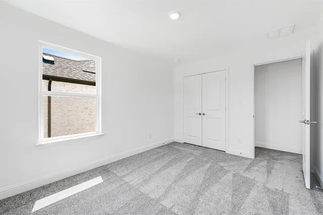 a bathroom with a sink double vanity granite tub and a mirror