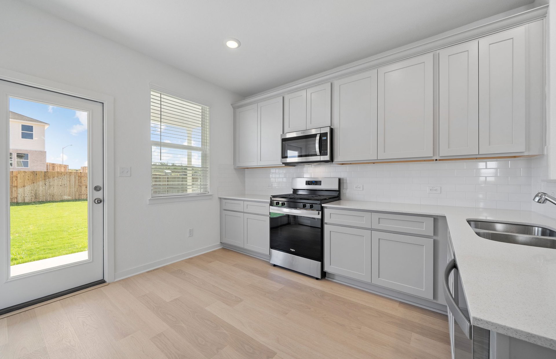 608 Rubber Tree Way Buda, TX 78610 - Photo 5 of 29 a kitchen with cabinets stainless steel appliances and window