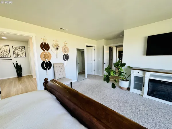 a view of a big room with wooden floor and a bathroom