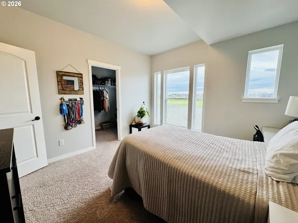a bedroom with furniture and a large window