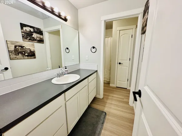 a bedroom with a bed flat screen tv and a window