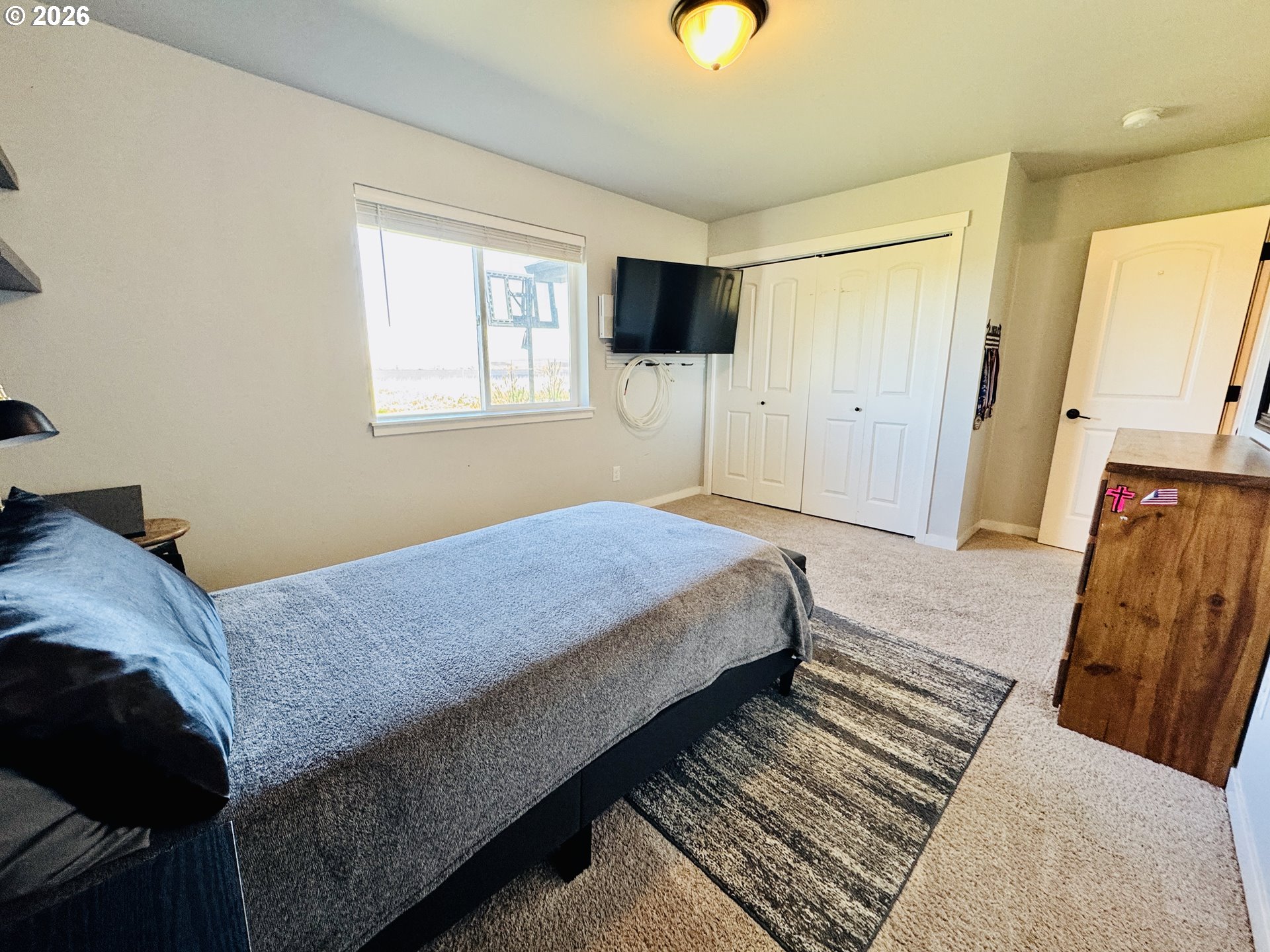 74969 Washington Lane Irrigon, OR 97844 - Photo 31 of 33 a bedroom with a bed flat screen tv and a window