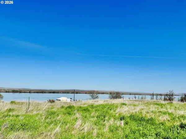 a view of a lake with a yard