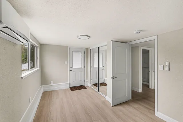 a view of a livingroom with wooden floor and window